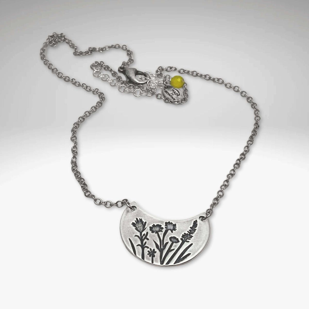 Wildflower Basket Necklace showcasing intricate floral design and delicate chain, perfect for spring and summer styles.