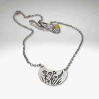 Wildflower Basket Necklace showcasing intricate floral design and delicate chain, perfect for spring and summer styles.