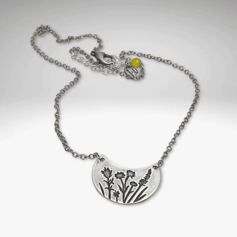 Wildflower Basket Necklace showcasing intricate floral design and delicate chain, perfect for spring and summer styles.