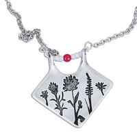 Wildflower Box Necklace featuring a matte silver finish with intricate floral designs and pink stones, perfect for any occasion.