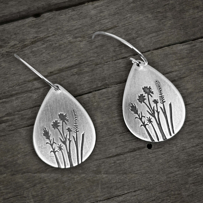 Wildflower Earrings crafted with a floral design featuring Indian Paintbrush and Wild Lupine on a rustic background.
