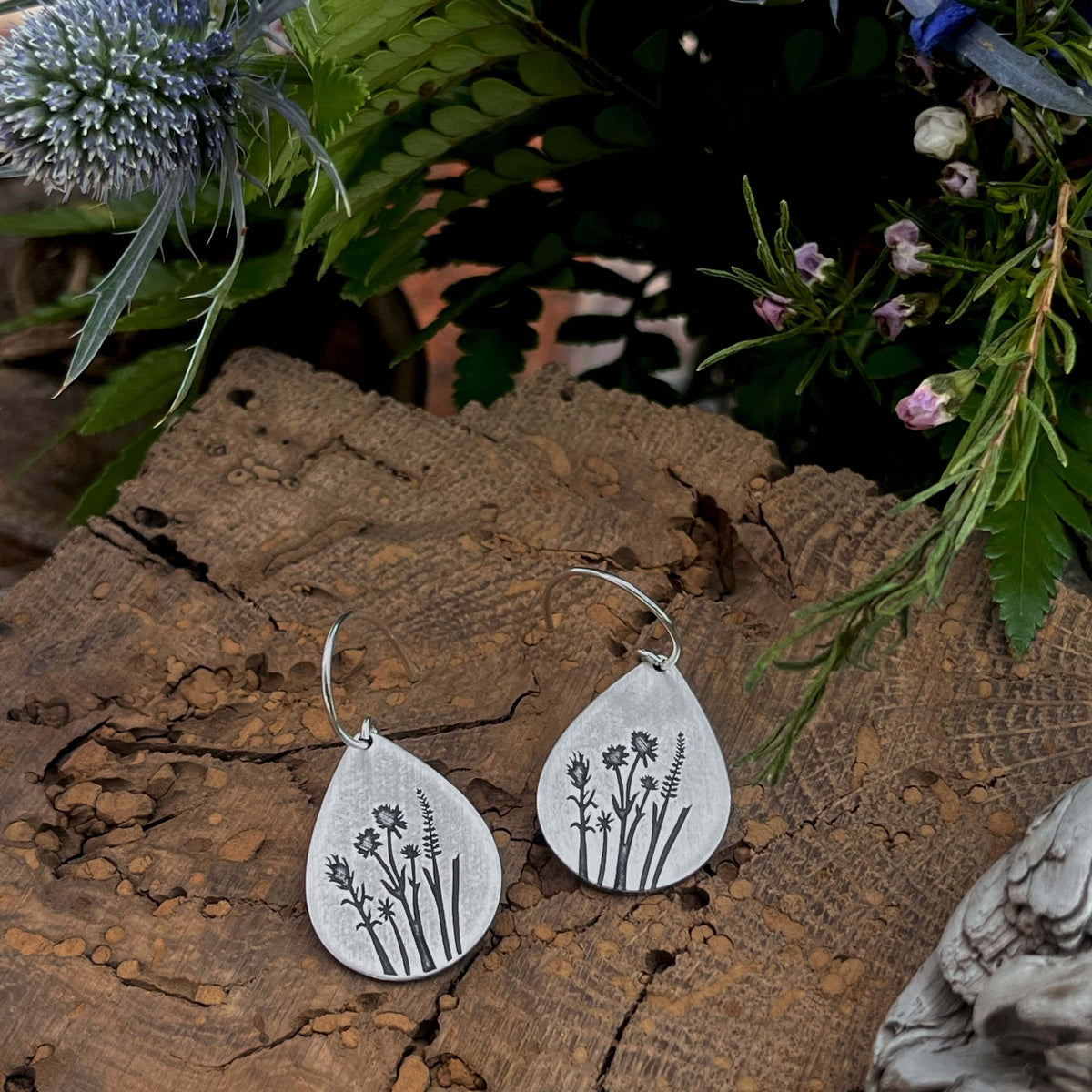 Wildflower Earrings featuring Indian Paintbrush and Wild Lupine on a wooden background with greenery.