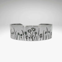 Wildflower Field Cuff featuring delicate wildflower designs on a silver bracelet for nature lovers.