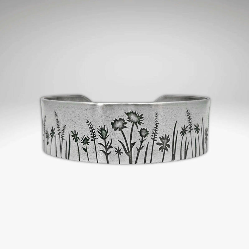 Wildflower Field Cuff featuring delicate wildflower designs on a silver bracelet for nature lovers.