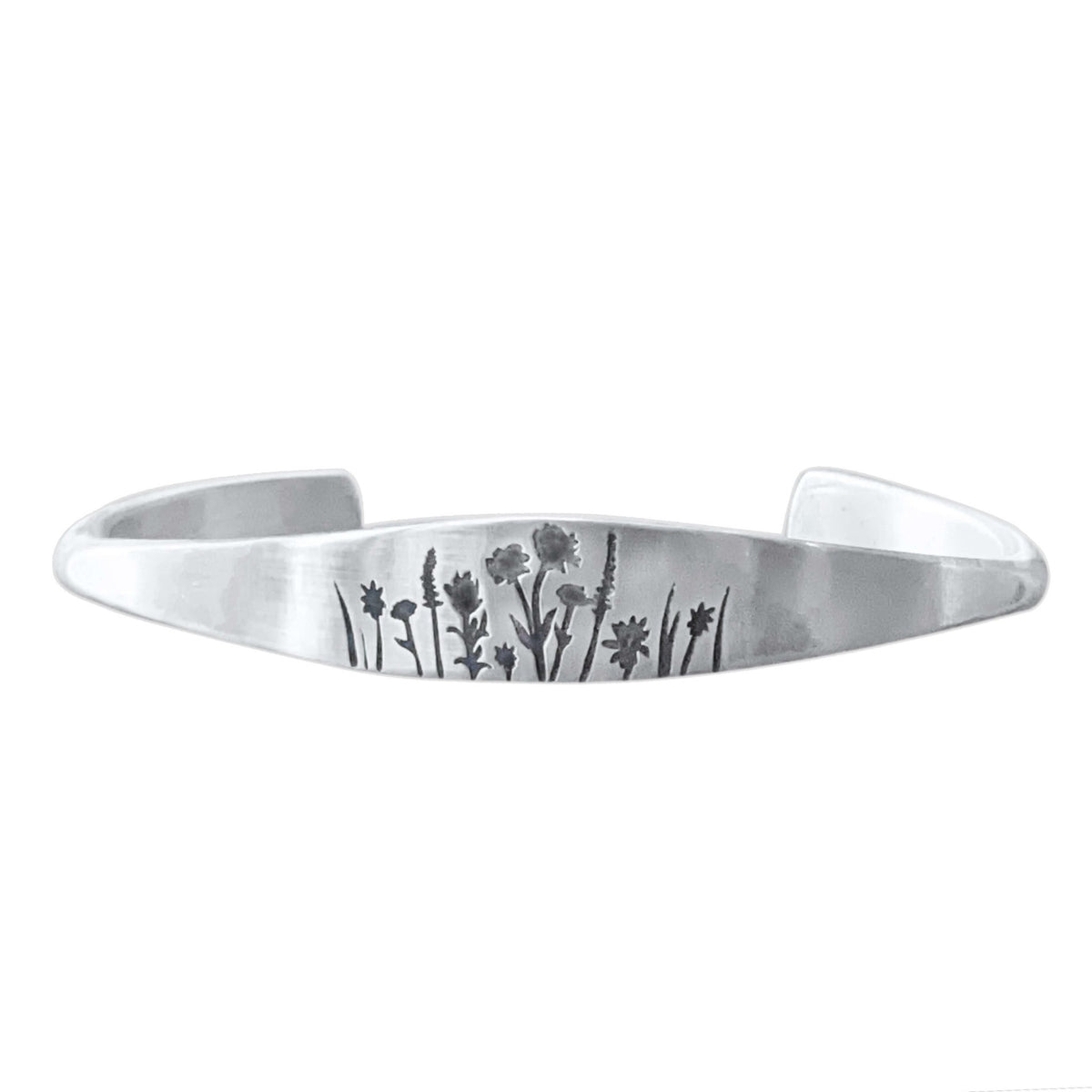 Wildflowers Signet Cuff featuring etched wildflower designs on a silver cuff bracelet.