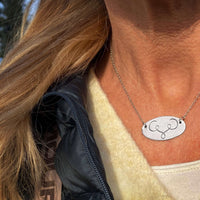 Close-up of the Ancient Buff Necklace worn on a person, showcasing its unique design and adjustable chain.