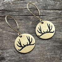 Antler Earrings featuring etched antlers on brass discs, hanging from sterling silver or brass earwires.