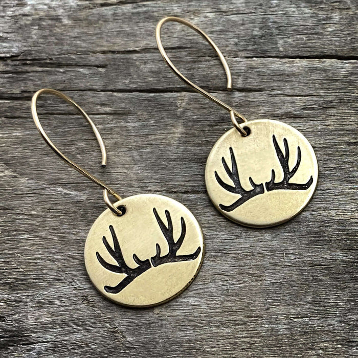 Antler Earrings featuring etched antlers on brass discs, hanging from sterling silver or brass earwires.