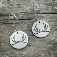Antler Earrings made from etched brass discs featuring a nature-inspired antler design and sterling silver earwires.