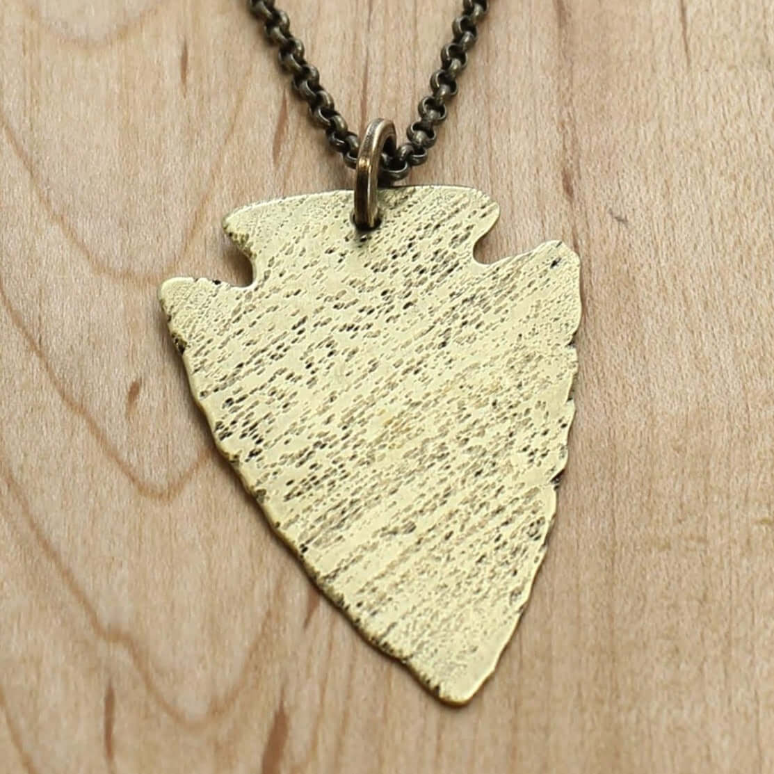 Arrowhead Long Layered Necklace featuring an antique brass pendant on a cable chain.