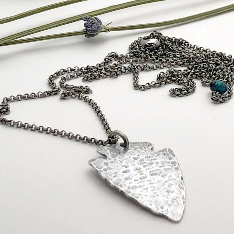 Arrowhead Long Layered Necklace featuring a hammered silver pendant on a silver chain.