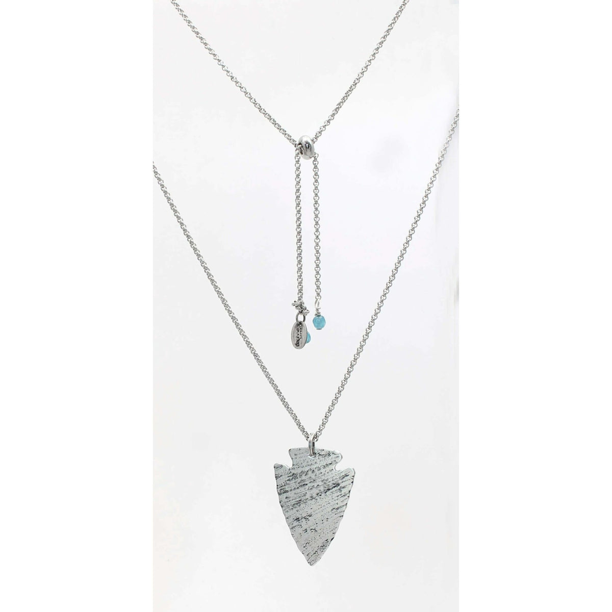 Arrowhead Long Layered Necklace featuring a hammered arrowhead pendant on a silver adjustable cable chain.