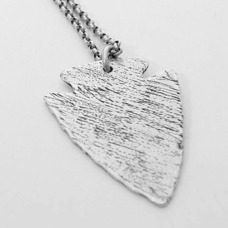 Arrowhead Long Layered Necklace featuring a hammered silver arrowhead pendant on a chain.