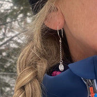 Close-up of a woman wearing Asteroids Earrings featuring oxidized chain and a textured design.