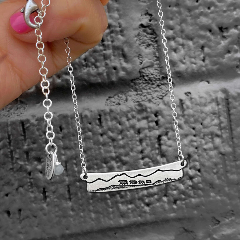 Handmade Bear Family Necklace featuring a mama bear and three cubs in a mountain landscape.