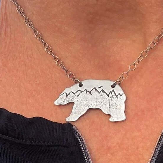 Bears in the Mountains Necklace featuring a bear silhouette with mountains, handmade in matte silver, 18" chain.