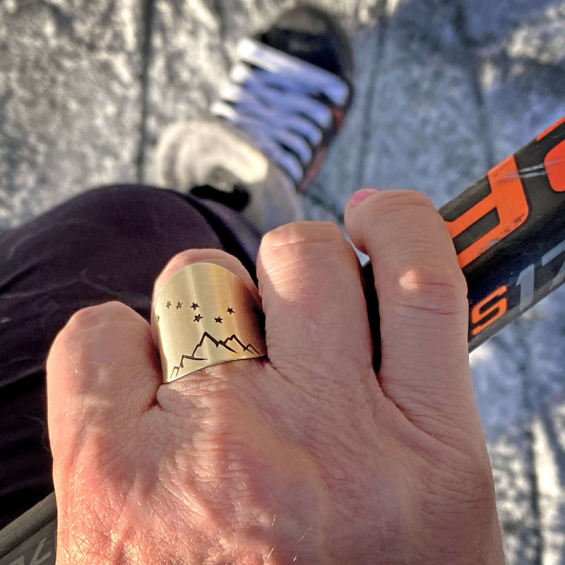 Big Dipper Adjustable Ring worn on a hand, featuring mountain and star etching, perfect for stargazers.