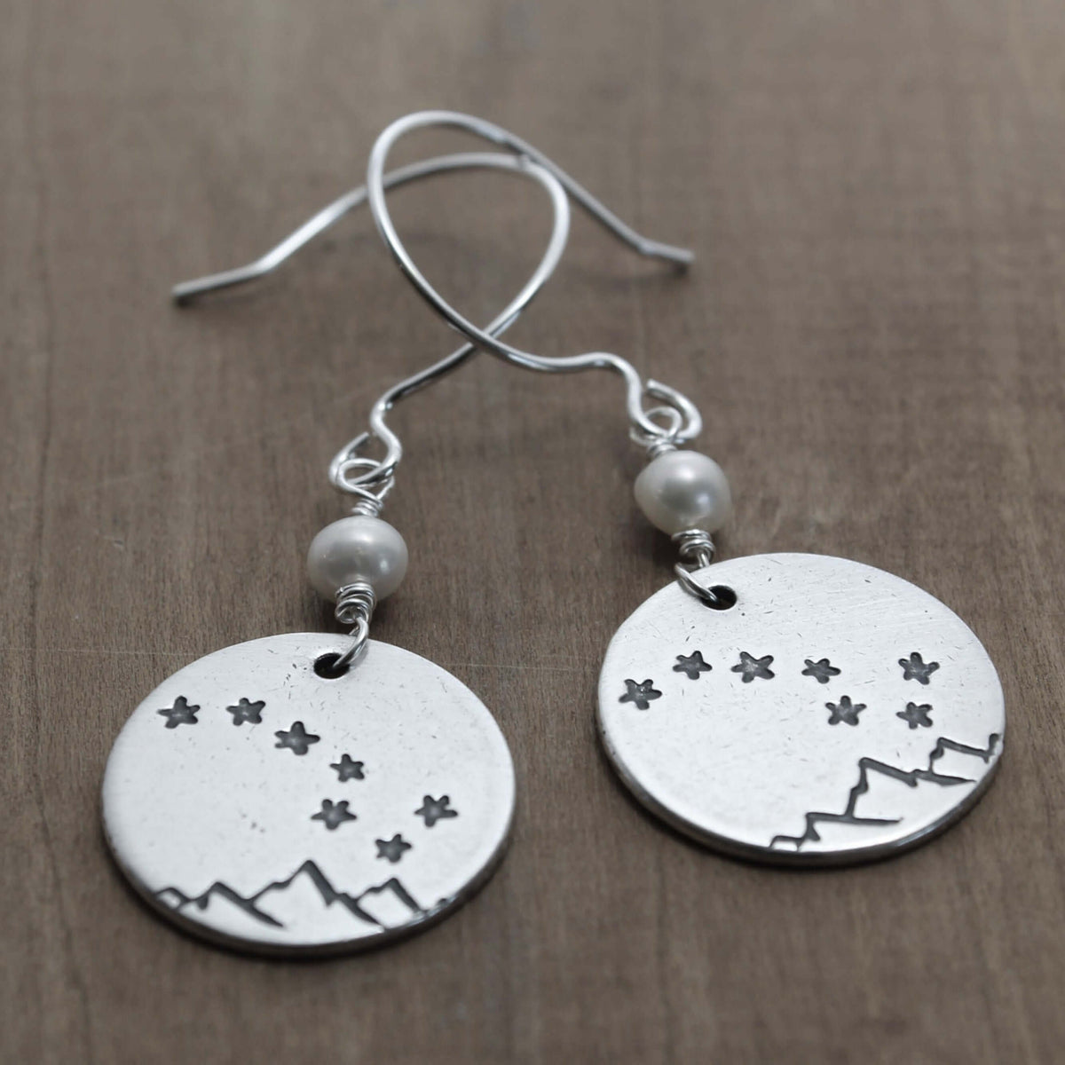 Big Dipper Earrings featuring etched stars and mountains on silver discs with freshwater pearl beads.