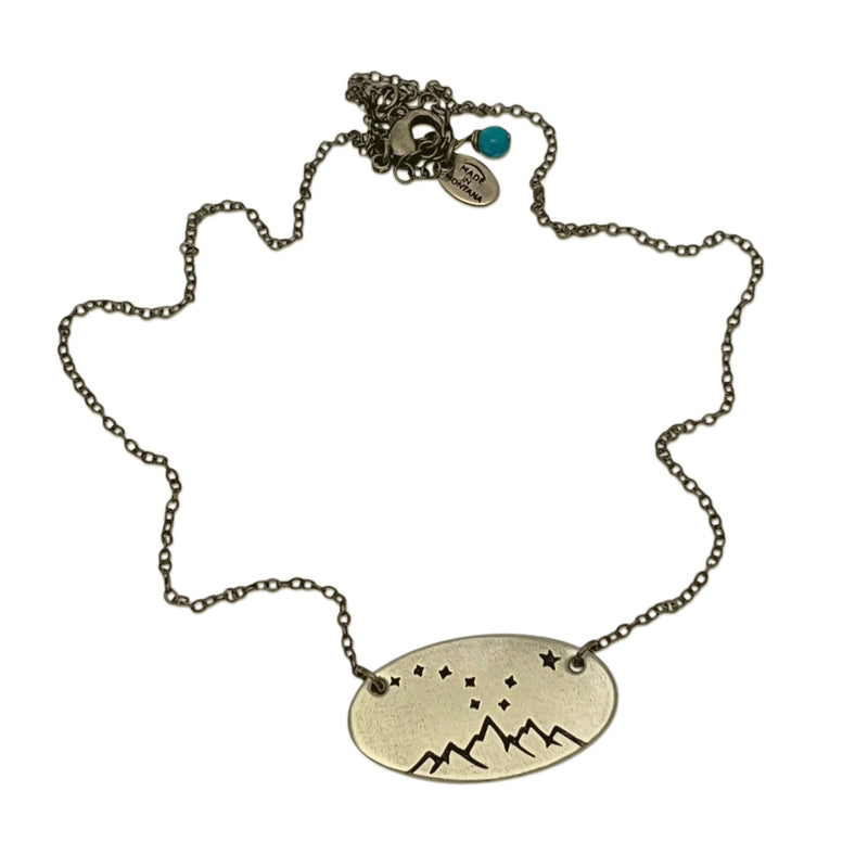 Big Dipper Necklace featuring a mountains and stars design on a delicate chain.