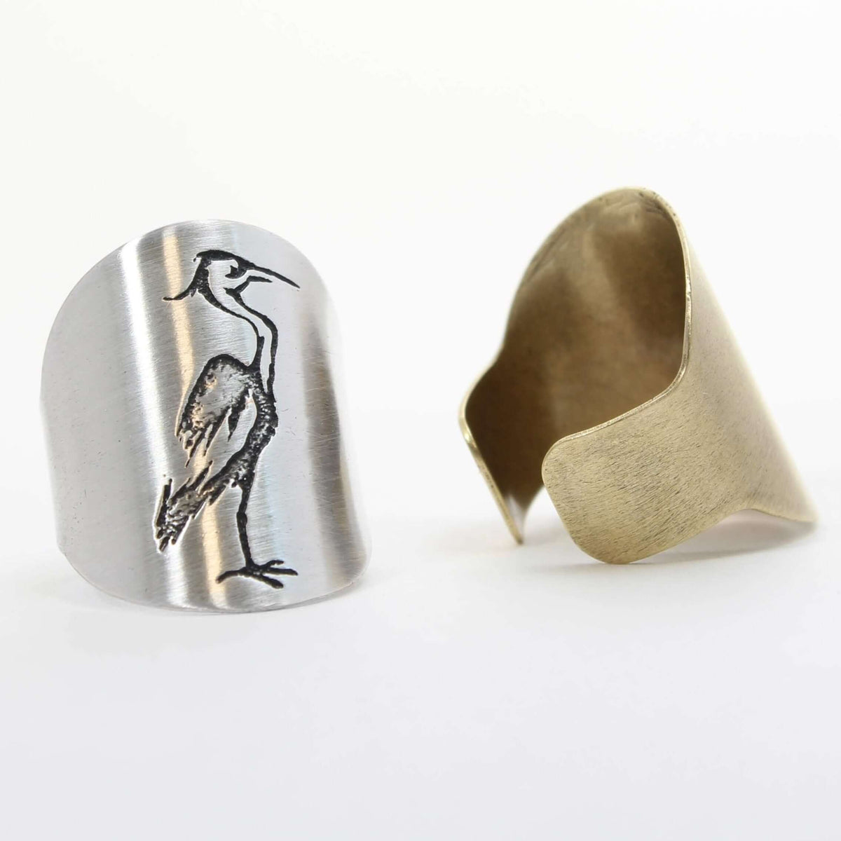 Blue Heron Adjustable Ring showcasing etched heron design on one side and a smooth metallic finish on the other.