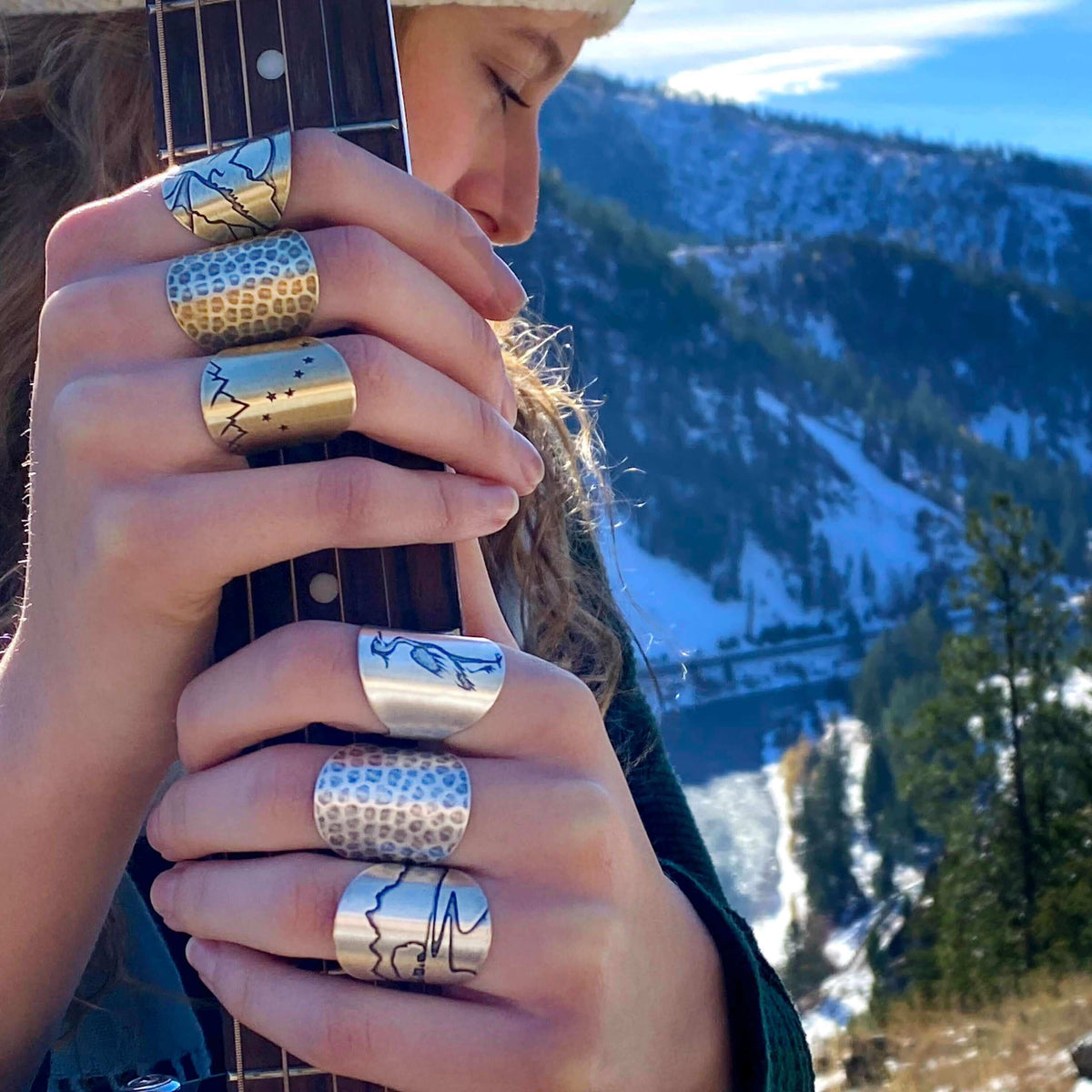 Buff in the Tetons Adjustable Ring showcased on hands playing guitar outdoors in the beautiful Tetons.