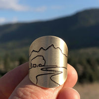 Buff in the Tetons Adjustable Ring with a silhouette of mountains, buffalo, and a river.