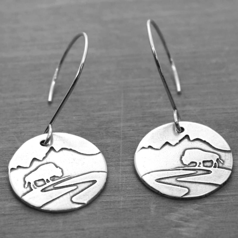 Buffalo in the Tetons Earring featuring etched brass design of bison and mountains, with reflective finish and safe earwires.