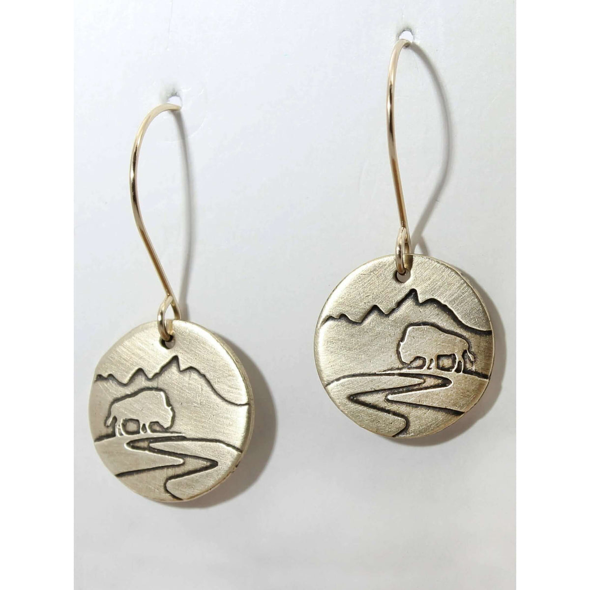 Buffalo in the Tetons Earring showcasing a buffalo and mountain design on solid brass in matte silver finish.