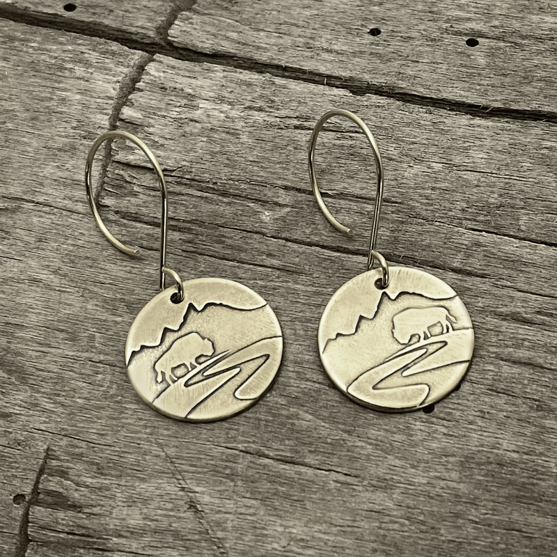 Buffalo in the Tetons Earring featuring etched buffalo and mountains on solid brass with a reflective design.