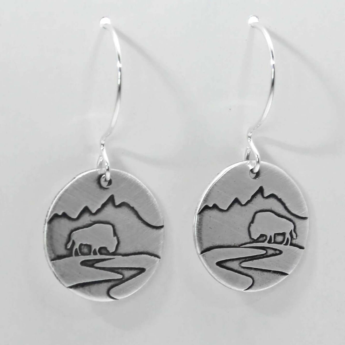 Buffalo in the Tetons Earring design featuring a bison and mountains on solid brass, finished in matte silver.
