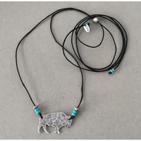 Buffalo Necklace featuring a rustic buffalo pendant and adjustable cord with blue beads.