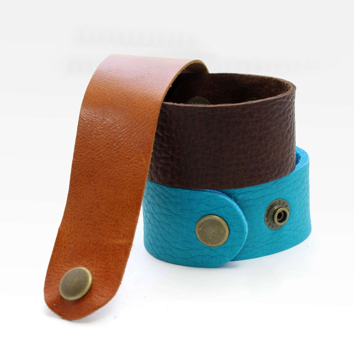 Echo Leather Cuff Bracelet in brown, tan, and turquoise leather with antique brass snaps.