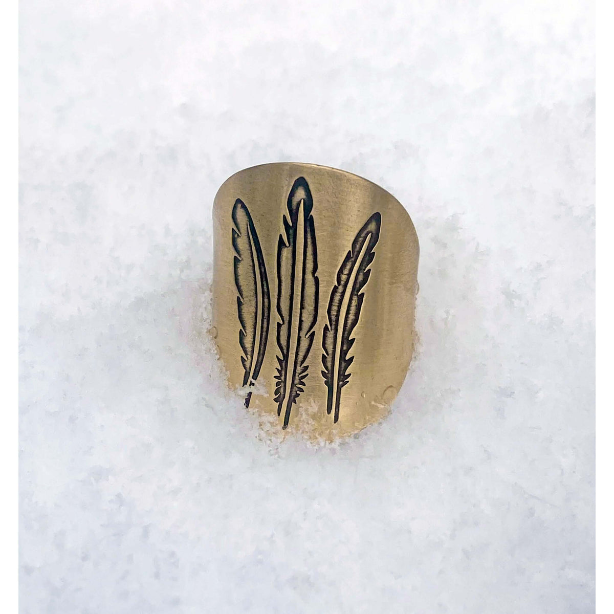 Feather Adjustable Ring featuring a three-feather design on a snowy background, perfect for nature lovers.