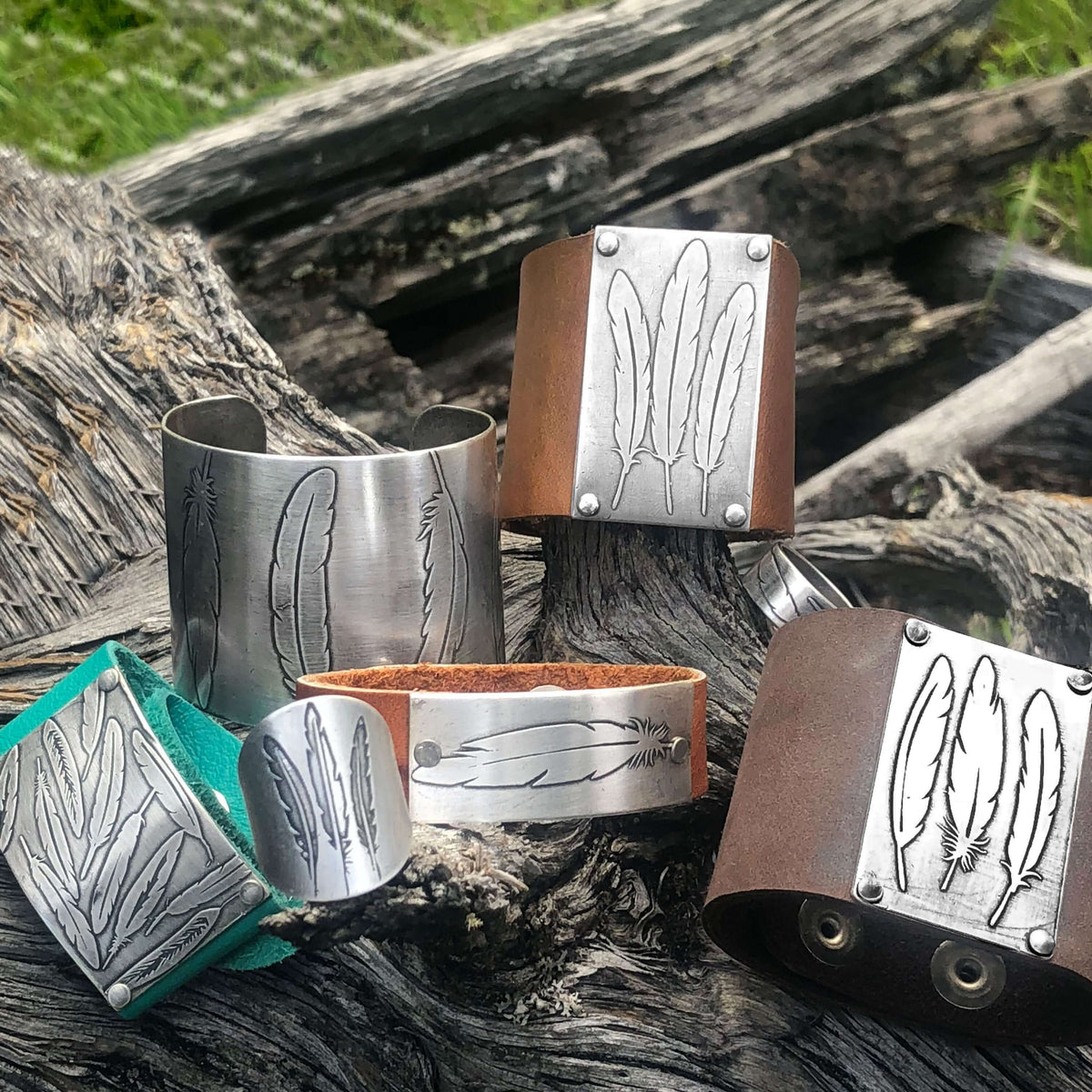 Five unique bracelets featuring feather designs on metal and leather, showcasing nature-inspired jewelry.