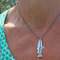 Fishin' Necklace worn on a person's neck, showcasing the intricate fish pendant design.