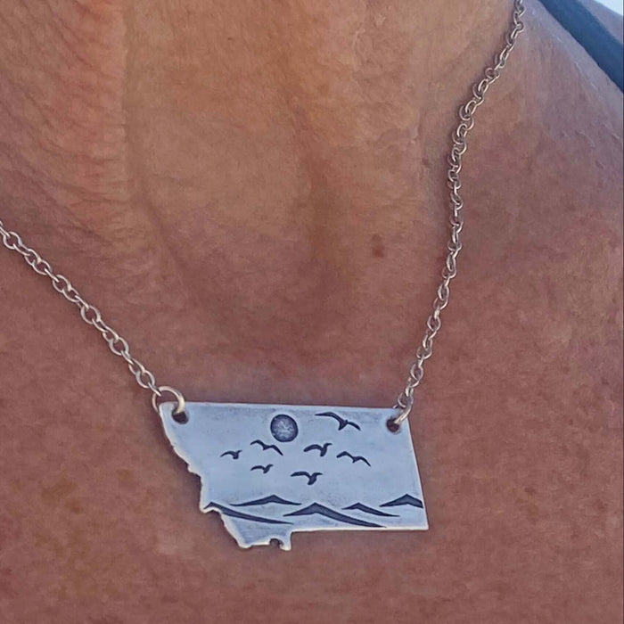 Flyover Montana - Necklace with Mountains birds and sun showcasing a serene Montana landscape.