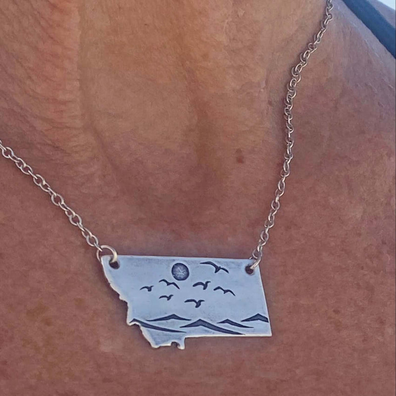 Flyover Montana - Necklace with Mountains birds and sun showcasing a serene Montana landscape.