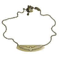 Freebird Necklace featuring an etched eagle design on a brass pendant with an adjustable cable chain.