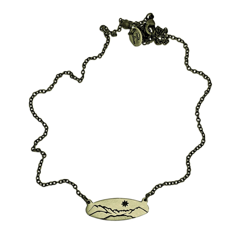 Glacier View Necklace in antique brass, featuring a mountain pendant and adjustable chain from 16" to 18".