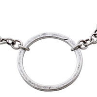 Close-up of a hammered Halo Necklace showcasing the circular pendant on an adjustable chain.