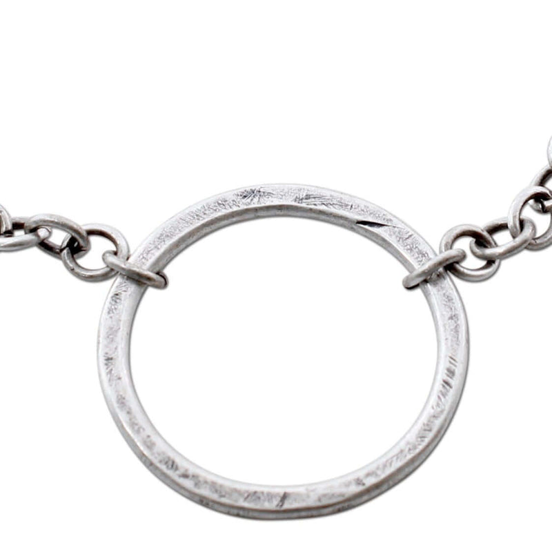 Close-up of a hammered Halo Necklace showcasing the circular pendant on an adjustable chain.