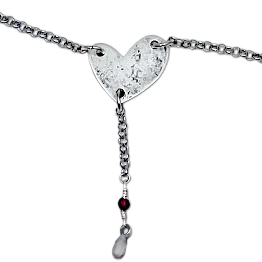 Heart Throb Y Necklace with heart pendant, silver chain, and decorative beads, symbolizing love and connection.