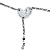 Heart Throb Y Necklace with heart pendant, silver chain, and decorative beads, symbolizing love and connection.