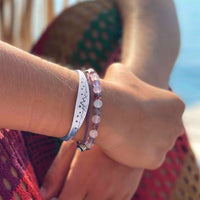 High Alpine Cuff Bracelet worn on wrist, featuring etched mountains, stars, and moon design.