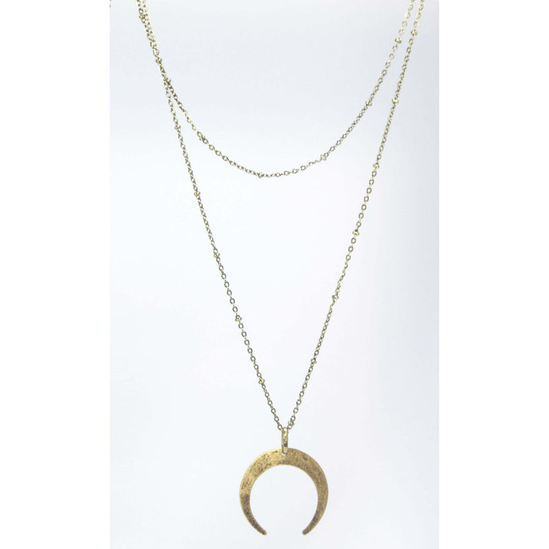 Horned Moon Necklace on satellite chain with gold pendant and layered chains.