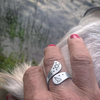 Howl Adjustable Ring worn on hand, featuring wolf, moon, and stars engravings in matte silver finish.