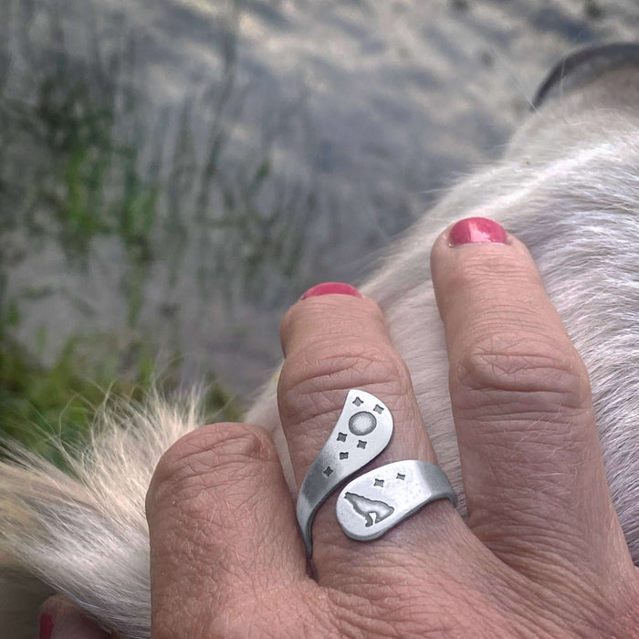 Howl Adjustable Ring worn on hand, featuring wolf, moon, and stars engravings in matte silver finish.