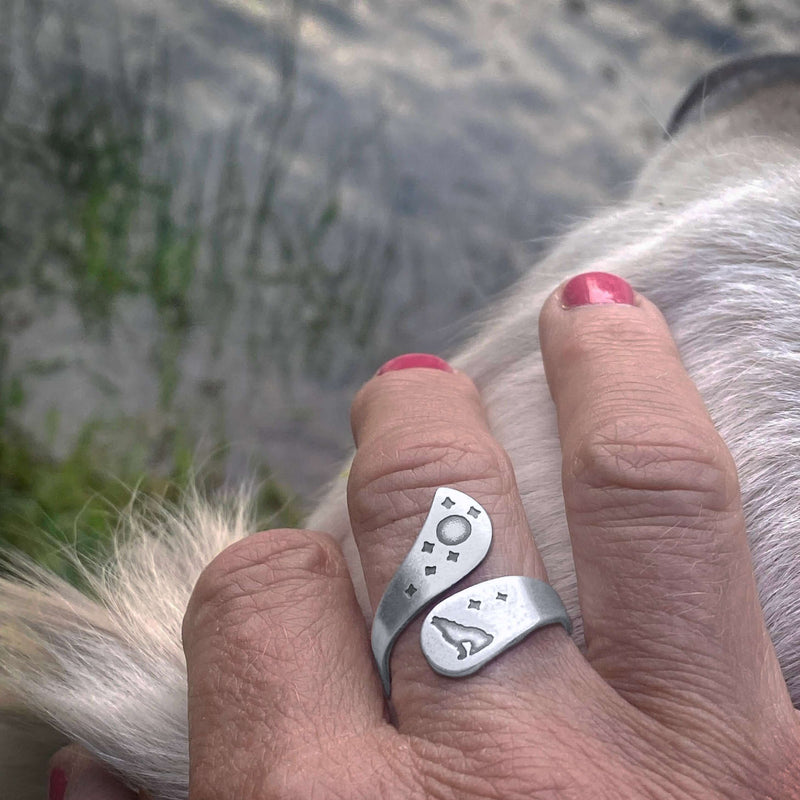 Howl Adjustable Ring worn on hand, featuring wolf, moon, and stars engravings in matte silver finish.