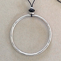 Hula Necklace with a silver-coated circle hoop and bead details on a monofilament cord.