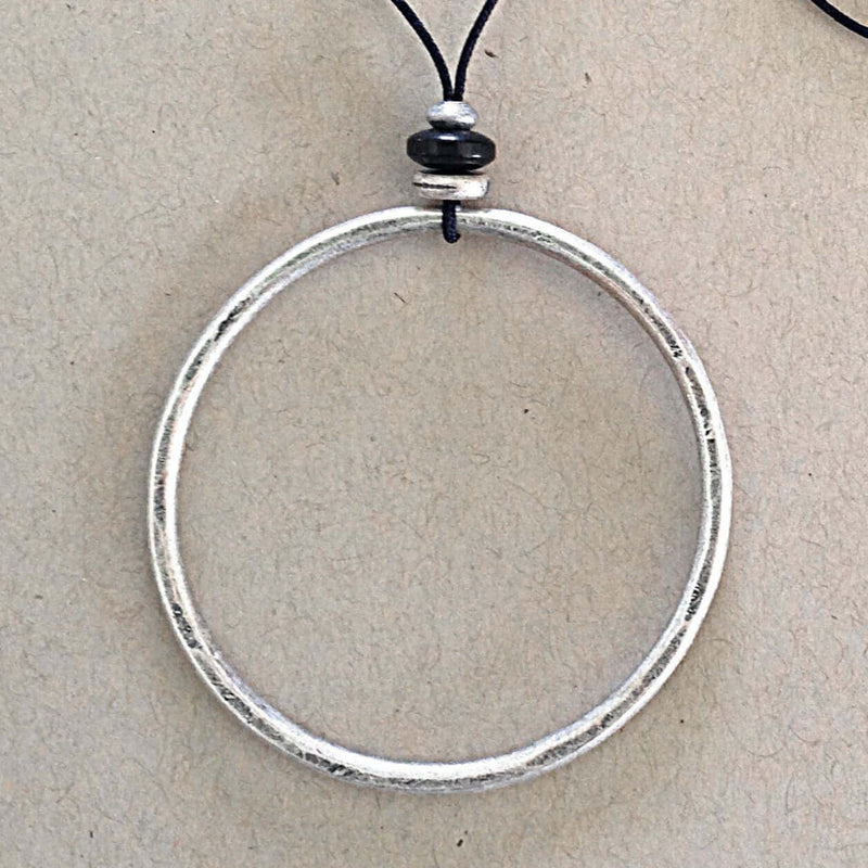 Hula Necklace with a silver-coated circle hoop and bead details on a monofilament cord.